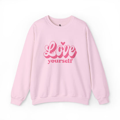 Pink sweatshirt with 'Love yourself' text on a white background